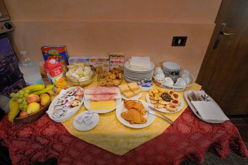 a table with food and plates of food on it at Hotel Piccolo in Termini Imerese