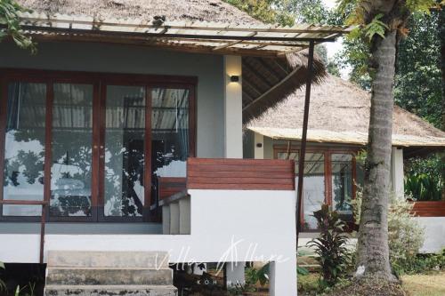 a house with a thatched roof at Villa Allure Koh Mak in Ko Mak