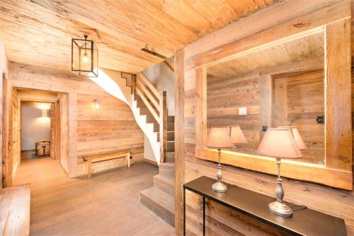 a hallway in a log cabin with a table and a mirror at Chalet Ourson Brun by Mrs Miggins in Grimentz