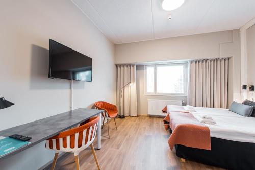 a hotel room with a bed and a desk at Forenom Aparthotel Espoo Leppävaara in Espoo