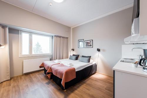 a bedroom with a large bed in a room at Forenom Aparthotel Espoo Leppävaara in Espoo