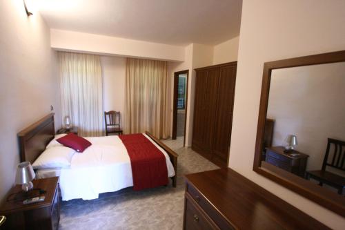 a hotel room with a bed and a mirror at Villa Del Colle in Monte San Giovanni Campano