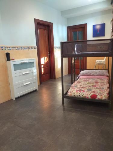 a bedroom with a bunk bed and a dresser at Casita Estela in Frigiliana
