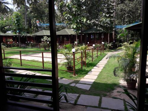 a view of a garden from a window at Club Palolem Resort in Palolem