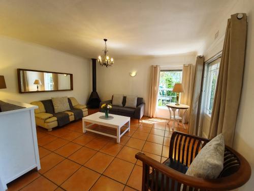 a living room with a couch and a table at Paradiso Guesthouse & Self-catering Cottage in Cape Town