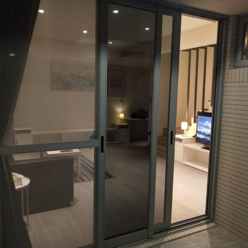 a glass door with a view of a room at In Fengchia in Taichung