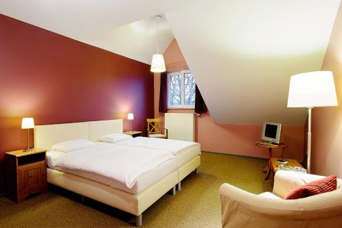 En eller flere senge i et værelse på B&B De Vroling