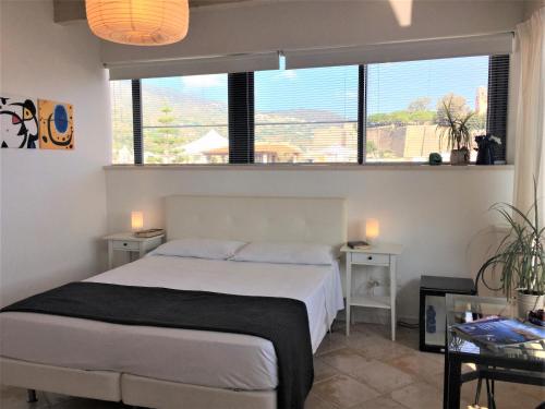 a bedroom with a bed and a large window at Casa Mafalda B&B in Lipari