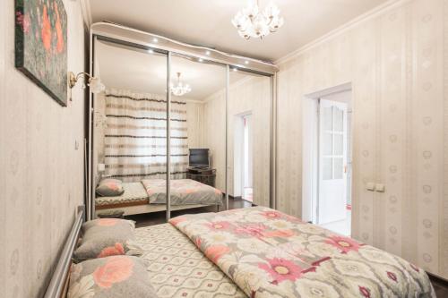 a bedroom with two beds and a mirror at Deribasovskay street apartments in Odesa