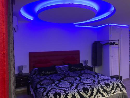 a blue room with a bed and a blue ceiling at Loft romántico in Algeciras