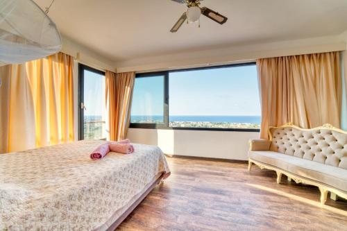 a bedroom with a bed and a large window at Spectacular Villa In Kyrenia in Kyrenia