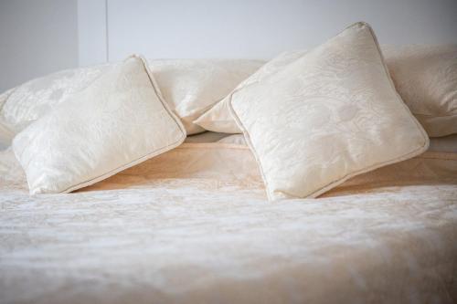 a bed with two pillows on top of it at Hayes House Killarney in Killarney