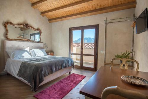 a bedroom with a bed and a table and a mirror at Conte Federico Apartments in Palermo