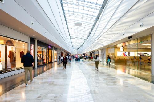 a group of people walking through a shopping mall at Staycity Aparthotels near Disneyland Paris in Bailly-Romainvilliers