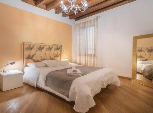 a bedroom with a large bed and a mirror at Appartamenti Venezia in Venice