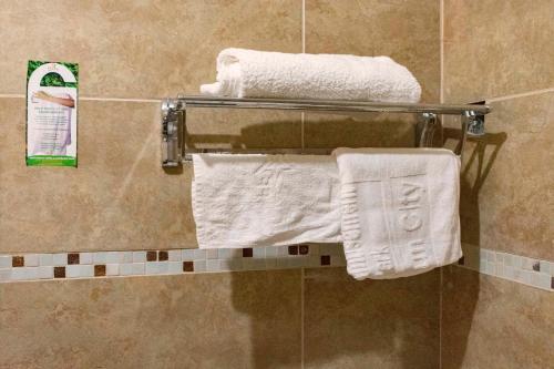 a towel rack in a bathroom with white towels at Fort Fun City Hotel Fort Portal in Fort Portal