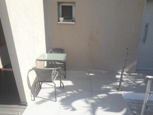 two chairs and a table on a patio at studio by the sea in Ashdod