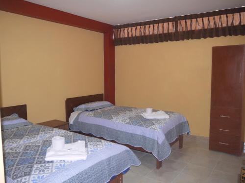 Postel nebo postele na pokoji v ubytování Hotel Suite Juliaca