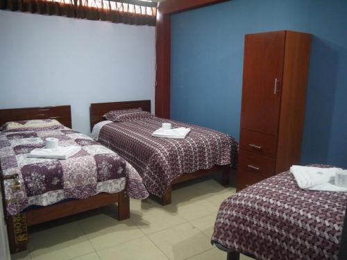 מיטה או מיטות בחדר ב-Hotel Suite Juliaca