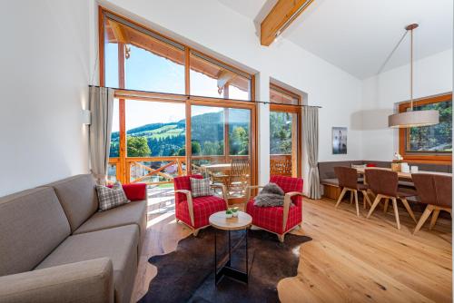 a living room with a couch and chairs and a table at Skylodge Alpine Homes in Haus im Ennstal