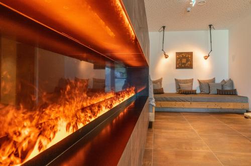 a fireplace in a living room with a fire place at Skylodge Alpine Homes in Haus im Ennstal
