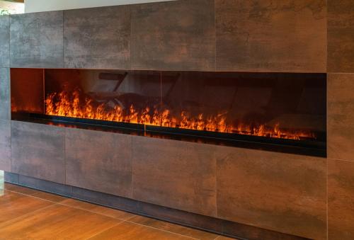 a fireplace is shown with flames in it at Skylodge Alpine Homes in Haus im Ennstal