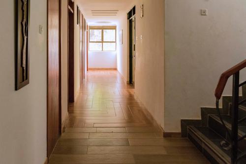 a hallway of a house with wooden floors at Fort Fun City Hotel Fort Portal in Fort Portal
