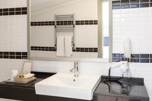 a bathroom with a white sink and a mirror at Hotellino Istanbul in Istanbul