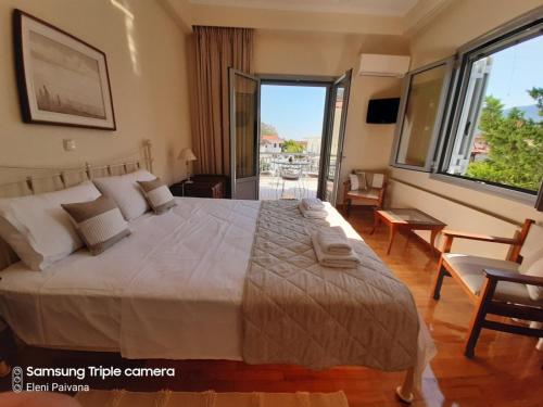 a bedroom with a large bed and a large window at New Garden's House (120m2) in Leonidion
