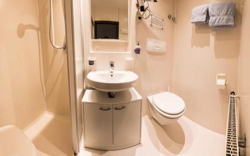 a small bathroom with a sink and a toilet at Hotel Gasthof Schäffler in Sonthofen