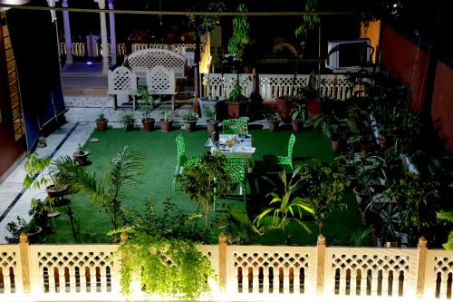 a miniature garden with plants and a fence at Ganesha Palace in Amritsar