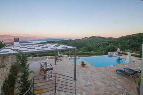 a villa with a swimming pool with a view at Villa Venetia Corfu in Agnítsini