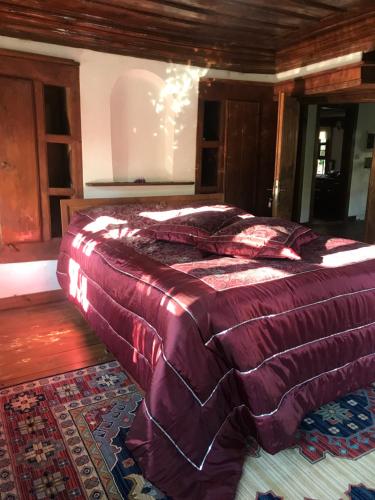 a bedroom with a bed with a purple comforter at Çamlıca Konak Çarsı in Safranbolu