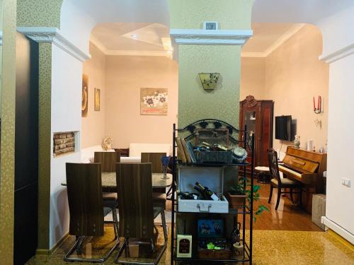 a dining room with a table and a fish tank at Guest house tm in Tbilisi City