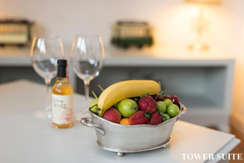 a bucket of fruit on a counter with wine glasses at Louis Appartements Galata in Istanbul