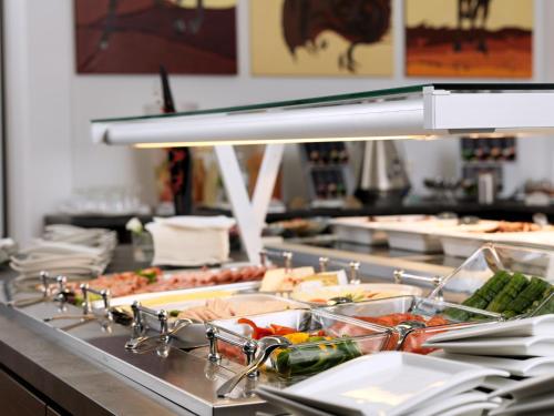 a buffet line with many different types of food at Best Western Plus Amedia Wien in Vienna