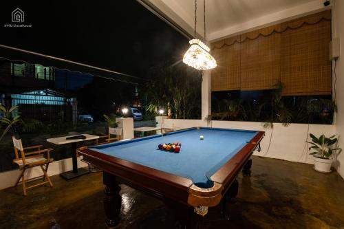 a pool table in the middle of a patio at night at SYRI Guesthouse Vientiane Hostel & Cafe in Vientiane