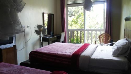 מיטה או מיטות בחדר ב-Pauline Hotel Lira
