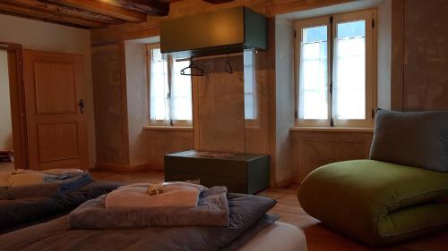 a living room with two couches and a chair at BnB Ai Cav Calanca in Arvigo