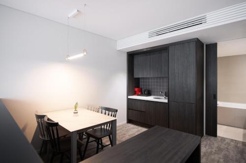 a kitchen and dining room with a table and chairs at Orakai Daehakro Hotel, BW Signature Collection in Seoul