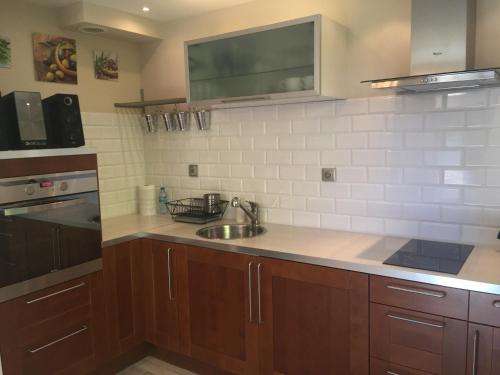 a kitchen with a sink and a counter top at Apartament Neptun in Jastrzębia Góra