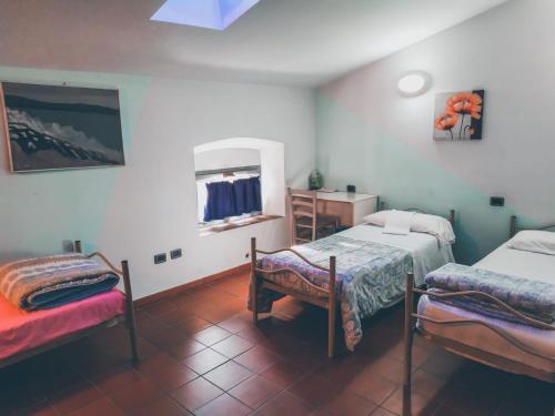 Katil atau katil-katil dalam bilik di Ostello Palazzo Pierantoni