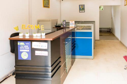 a lobby with a counter with a welcome sign at Fort Fun City Hotel Fort Portal in Fort Portal