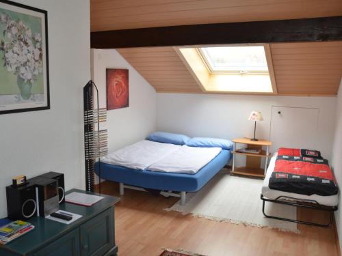 a bedroom with a blue bed and a skylight at Ferienwohnung Thelen in Wallbach