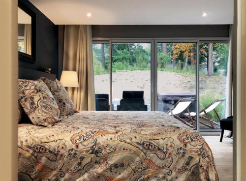a bedroom with a bed and a view of a beach at Les Tchanquées in Le Touquet-Paris-Plage