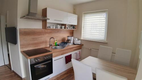 a small kitchen with a sink and a stove at Ferienwohnung Smillenzweg mit Garten in Lohme