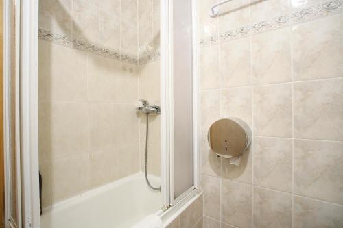 a bathroom with a shower with a shower head at Pensión San Telmo / San Juan in San Sebastián