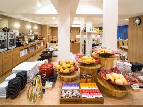 a buffet of food on a table in a restaurant at Super Hotel Ikebukuro-Eki Kitaguchi in Tokyo