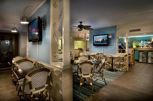 a dining room with a bar and a table and chairs at Landmark Resort in Myrtle Beach