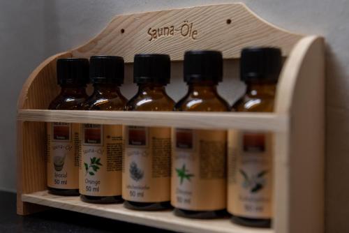a shelf with a bunch of bottles of sauce at Apartments Adlerhorst Top 1 Zell am See including Zell am See-Kaprun Summercard in Zell am See